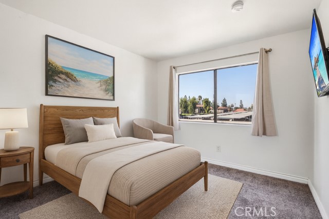 1142 West Blaine Street, Unit 201 Riverside, CA 92507 - Photo 12 of 24 a bedroom with a bed and a painting on the wall