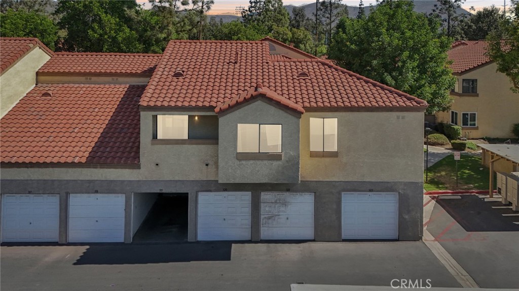 1142 West Blaine Street, Unit 201 Riverside, CA 92507 - Photo 23 of 24 a front view of a house with a garden