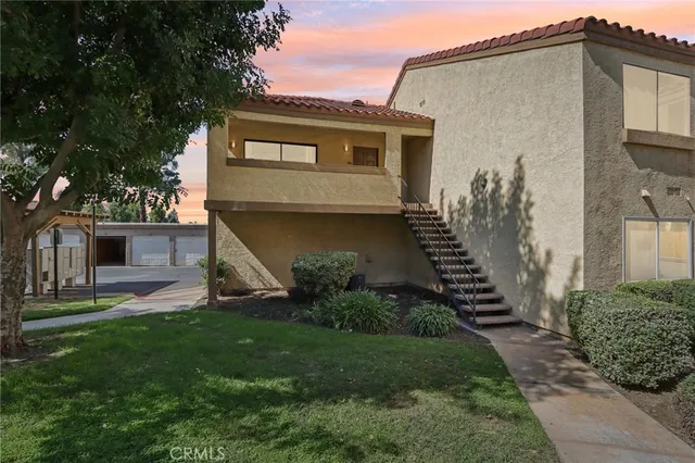 a front view of house with a garden
