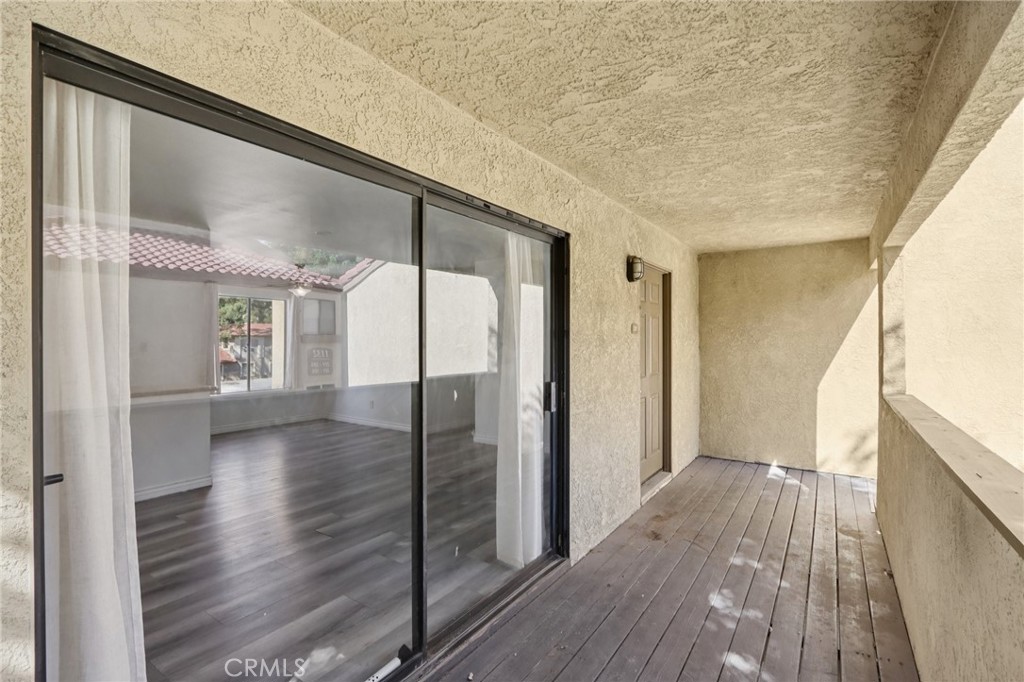1142 West Blaine Street, Unit 201 Riverside, CA 92507 - Photo 5 of 24 a view of a hallway with wooden floor and staircase
