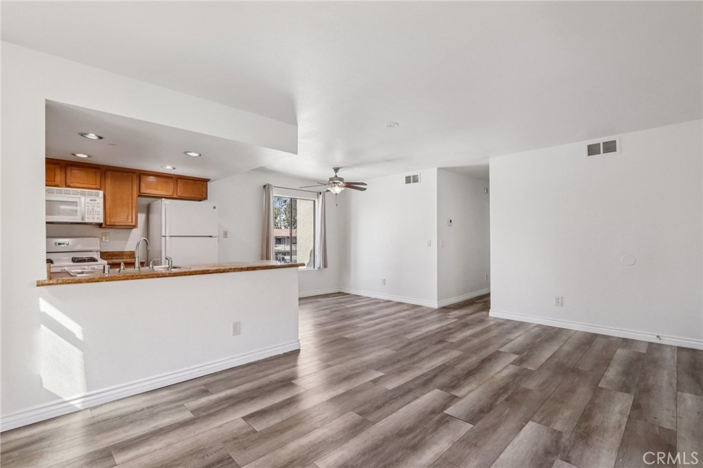 1142 West Blaine Street, Unit 201 Riverside, CA 92507 - Photo 7 of 24 a view of kitchen with wooden floor