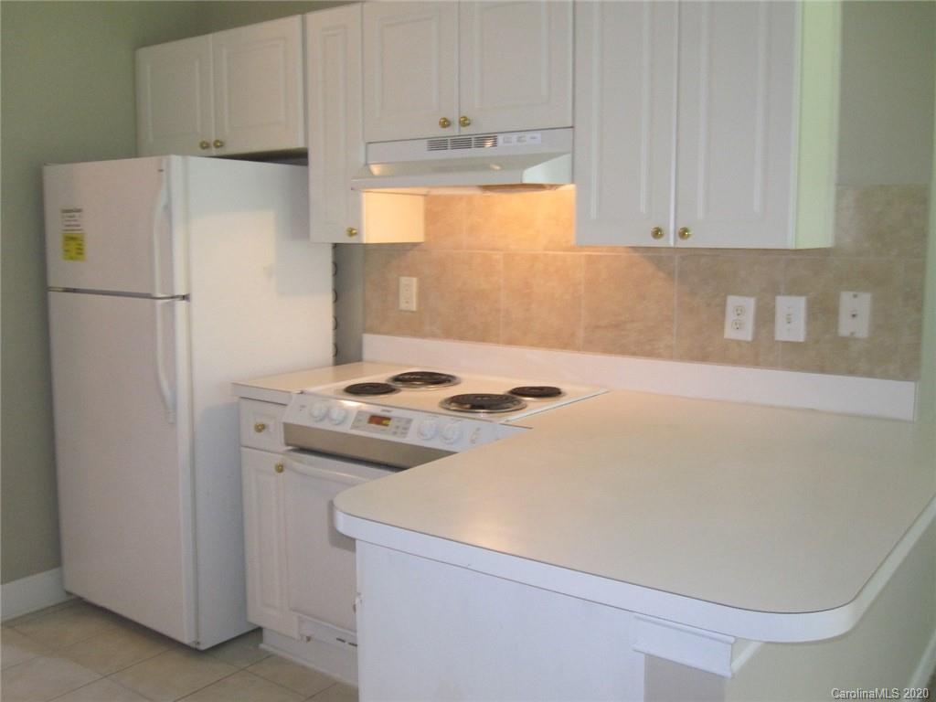 9223 Meadow Vista Road Charlotte, NC 28213 - Photo 4 of 13 a white refrigerator freezer sitting in a kitchen