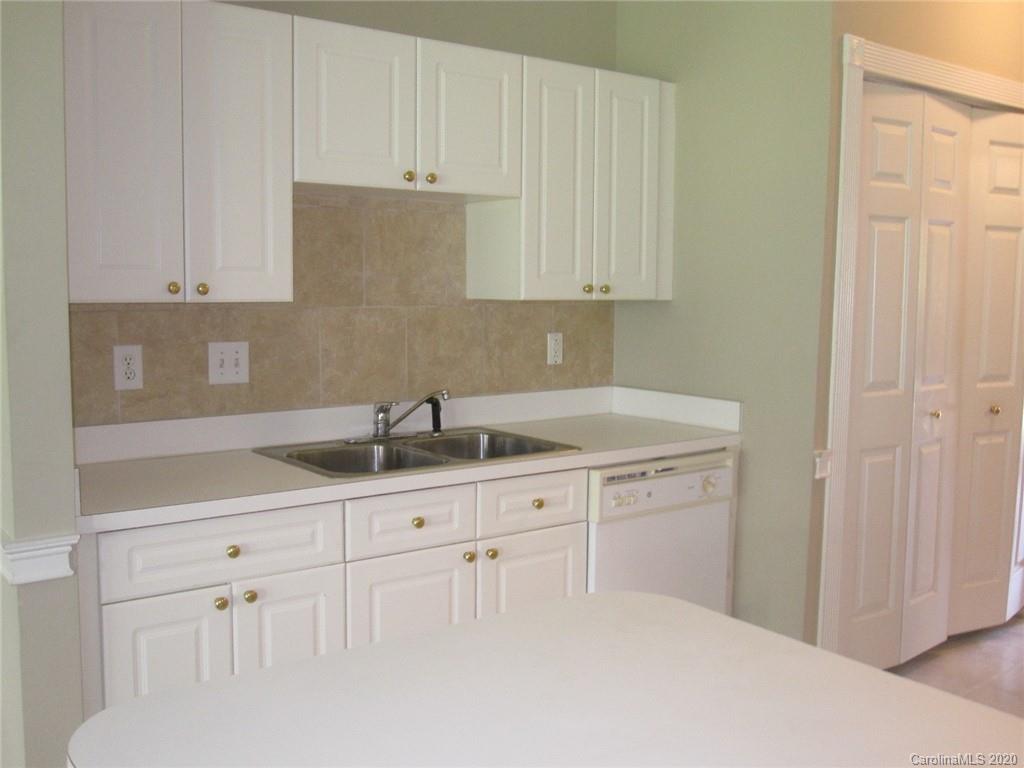 9223 Meadow Vista Road Charlotte, NC 28213 - Photo 5 of 13 a kitchen with white cabinets and sink