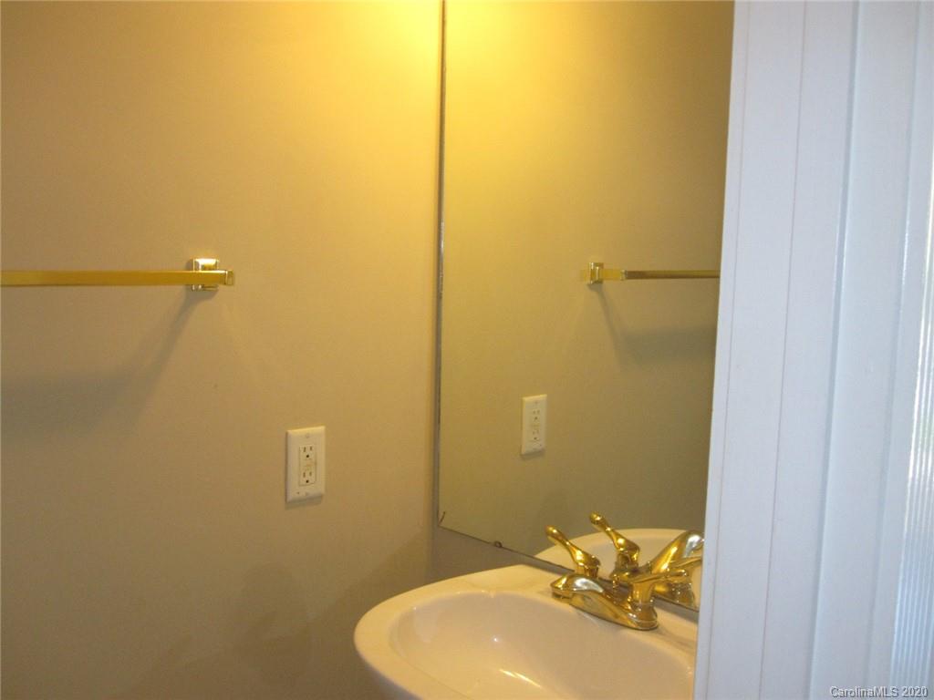 9223 Meadow Vista Road Charlotte, NC 28213 - Photo 9 of 13 a bathroom with a sink and mirror