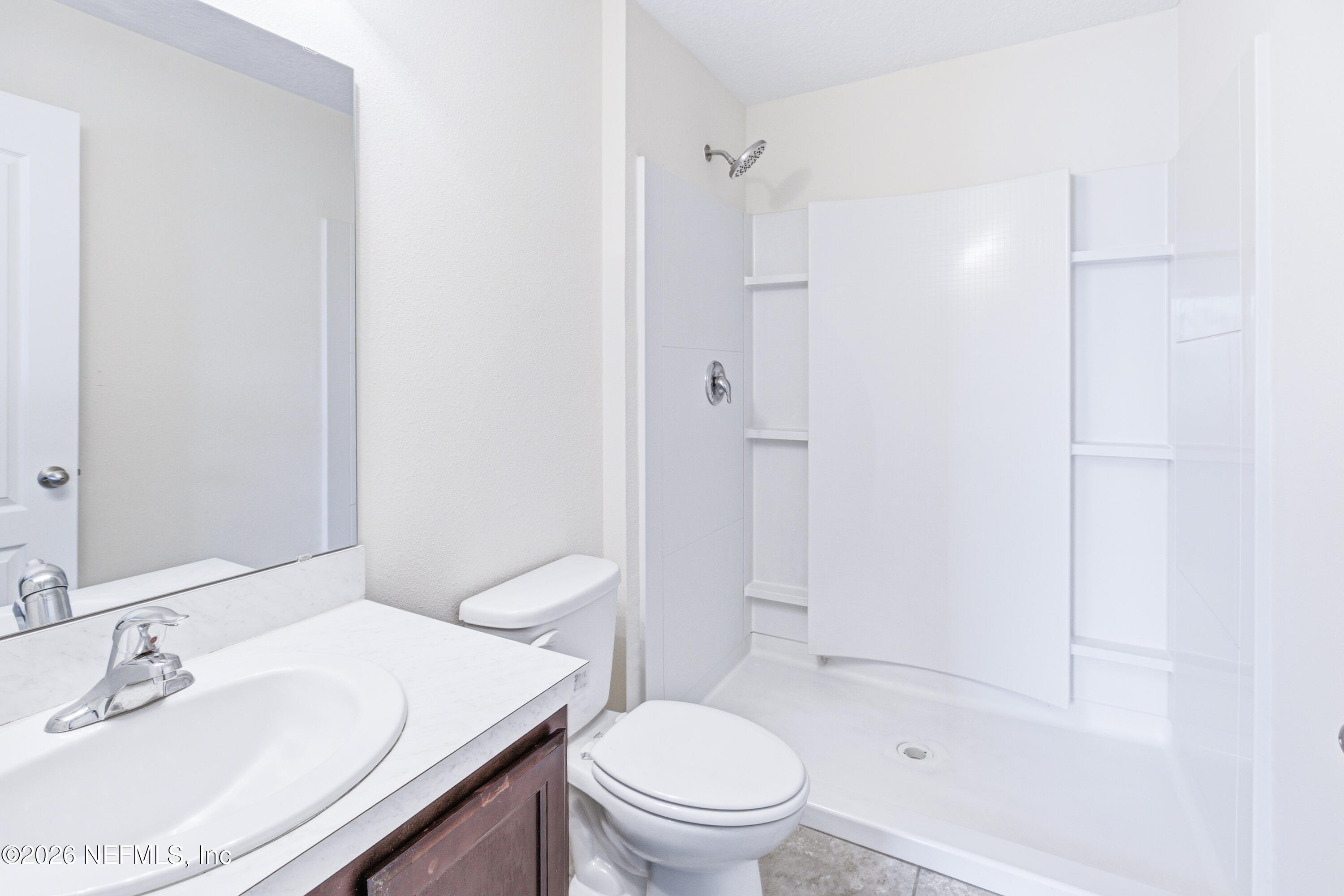 821 Golden Lake Loop St. Augustine, FL 32084 - Photo 12 of 27 a bathroom with a sink a toilet and shower