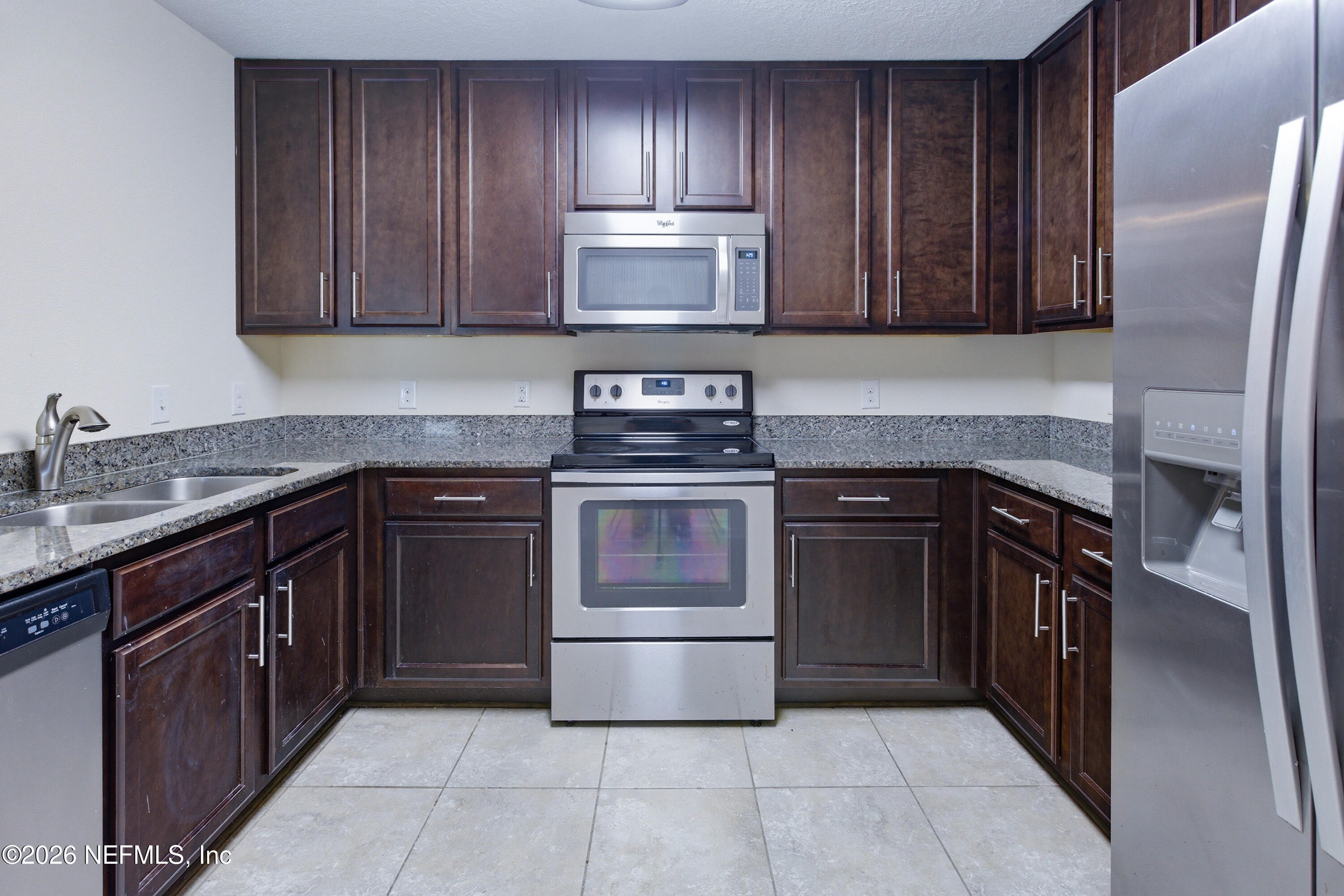 821 Golden Lake Loop St. Augustine, FL 32084 - Photo 7 of 27 a kitchen with stainless steel appliances granite countertop a stove and a refrigerator