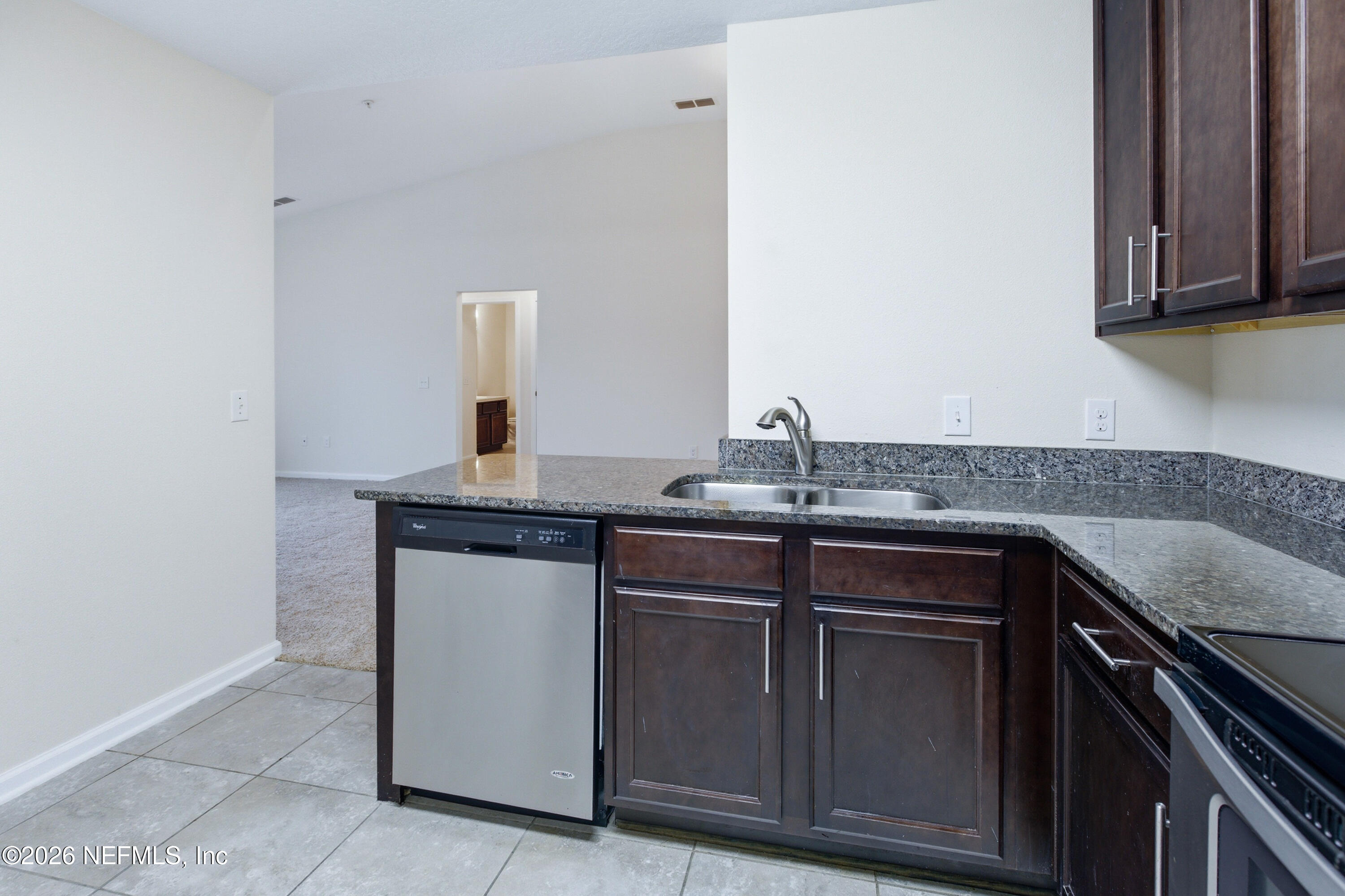 821 Golden Lake Loop St. Augustine, FL 32084 - Photo 8 of 27 a kitchen with granite countertop a sink and cabinets