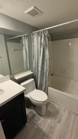 a bathroom with a toilet a sink and bathtub