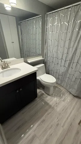 a bathroom with a sink toilet and shower