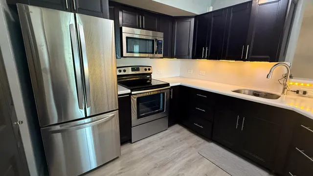 a kitchen with a refrigerator stove and sink