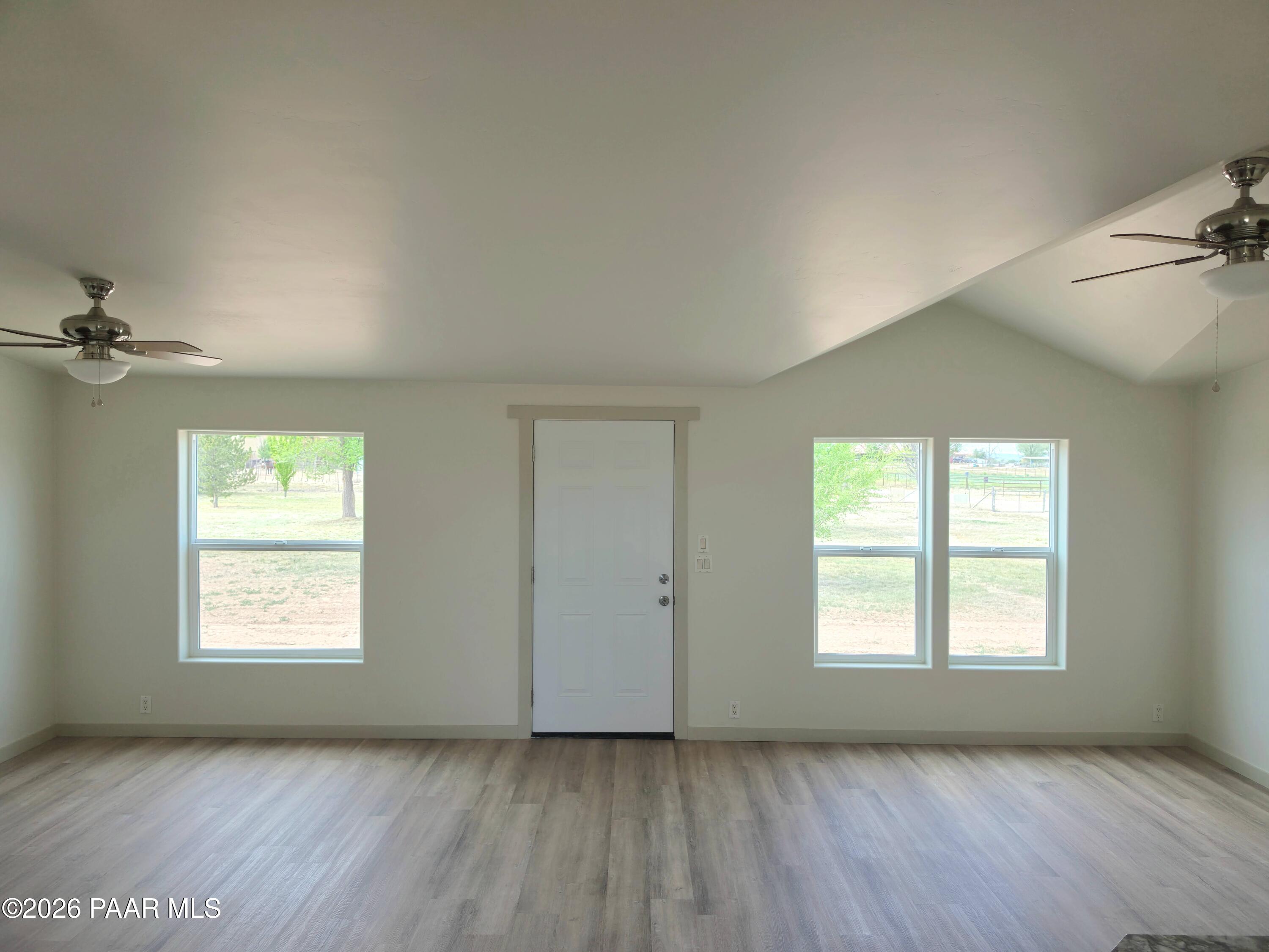 23525 North Ropers Lane Paulden, AZ 86334 - Photo 2 of 25 a view of an empty room with a window and wooden floor