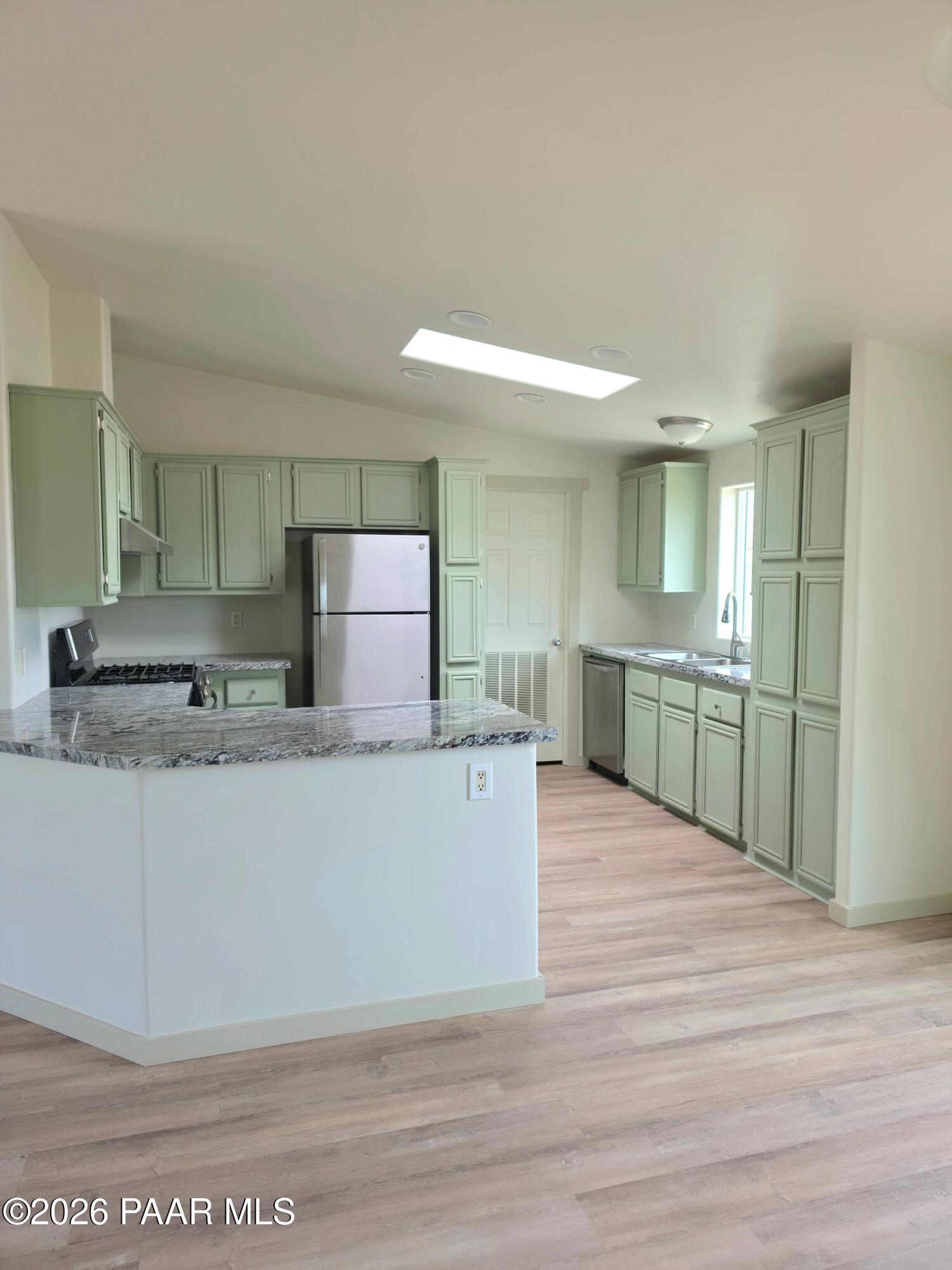 23525 North Ropers Lane Paulden, AZ 86334 - Photo 4 of 25 a large kitchen with kitchen island a sink stainless steel appliances and cabinets