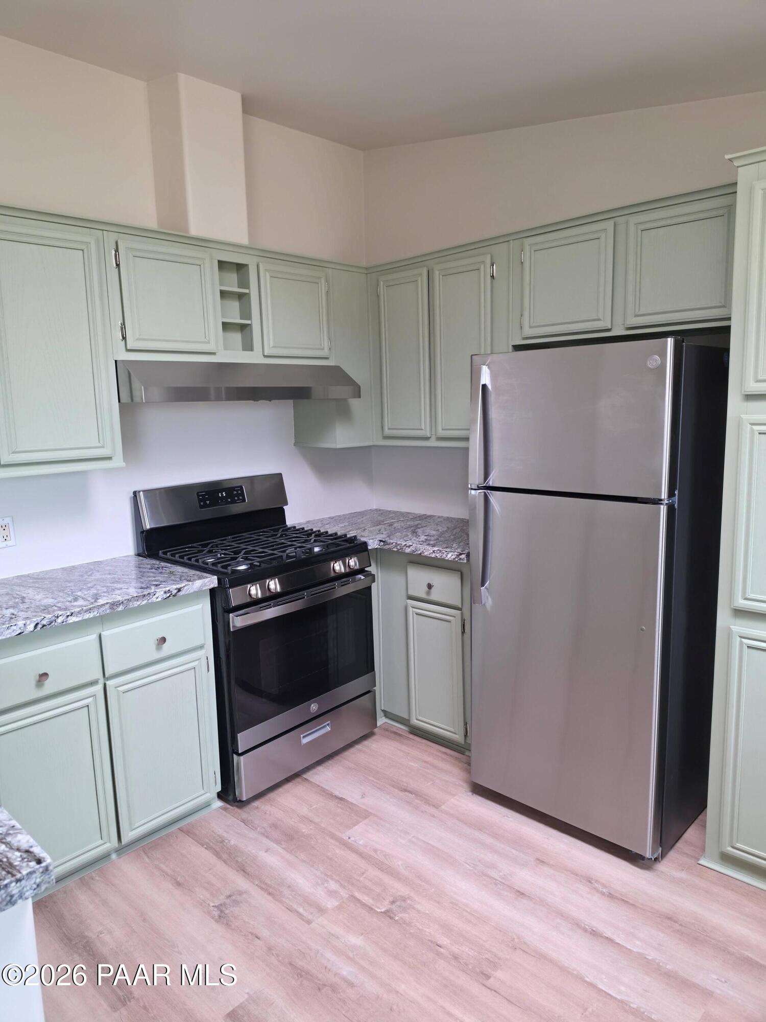 23525 North Ropers Lane Paulden, AZ 86334 - Photo 6 of 25 a kitchen with a refrigerator and a stove