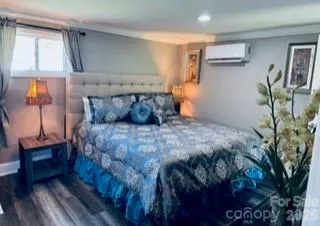 a bed sitting in a bedroom next to a window