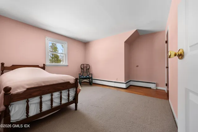 a bedroom with furniture and a window