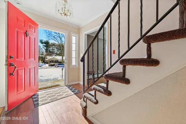 a view of entryway and hall with wooden floor