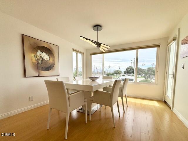 3521 Sunset Lane Oxnard, CA 93035 - Photo 14 of 37 a dining room with furniture a chandelier and wooden floor