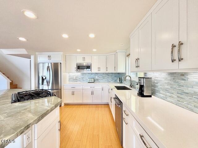 3521 Sunset Lane Oxnard, CA 93035 - Photo 18 of 37 a kitchen with stainless steel appliances granite countertop a sink and cabinets