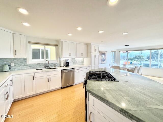 3521 Sunset Lane Oxnard, CA 93035 - Photo 19 of 37 a kitchen with a sink a window and cabinets