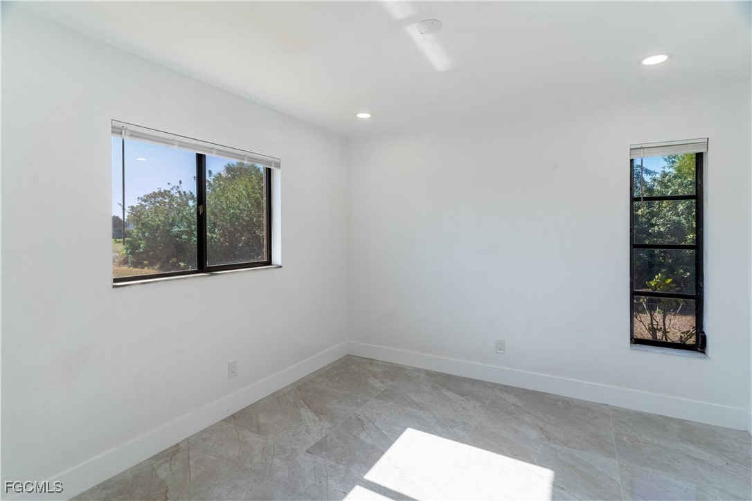720 Chavers Street East Lehigh Acres, FL 33974 - Photo 19 of 35 an empty room with windows