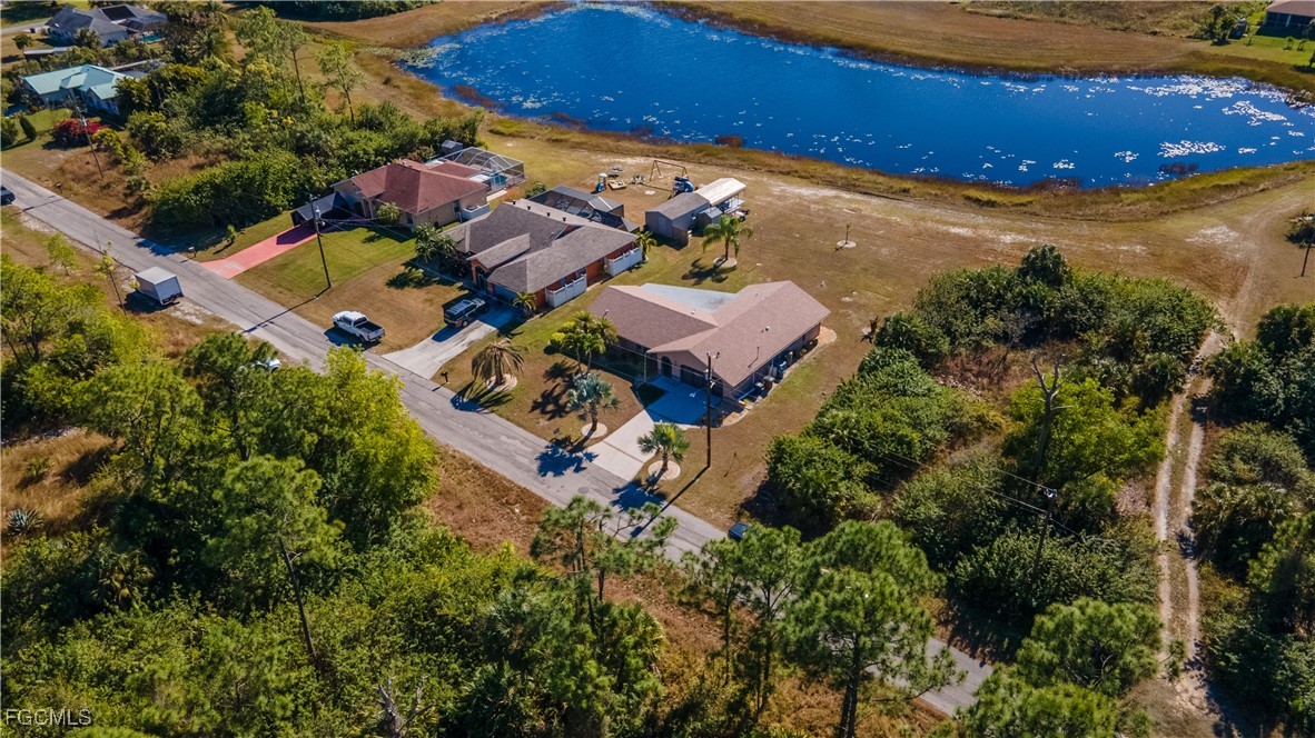 720 Chavers Street East Lehigh Acres, FL 33974 - Photo 2 of 35 an aerial view of a house with a garden