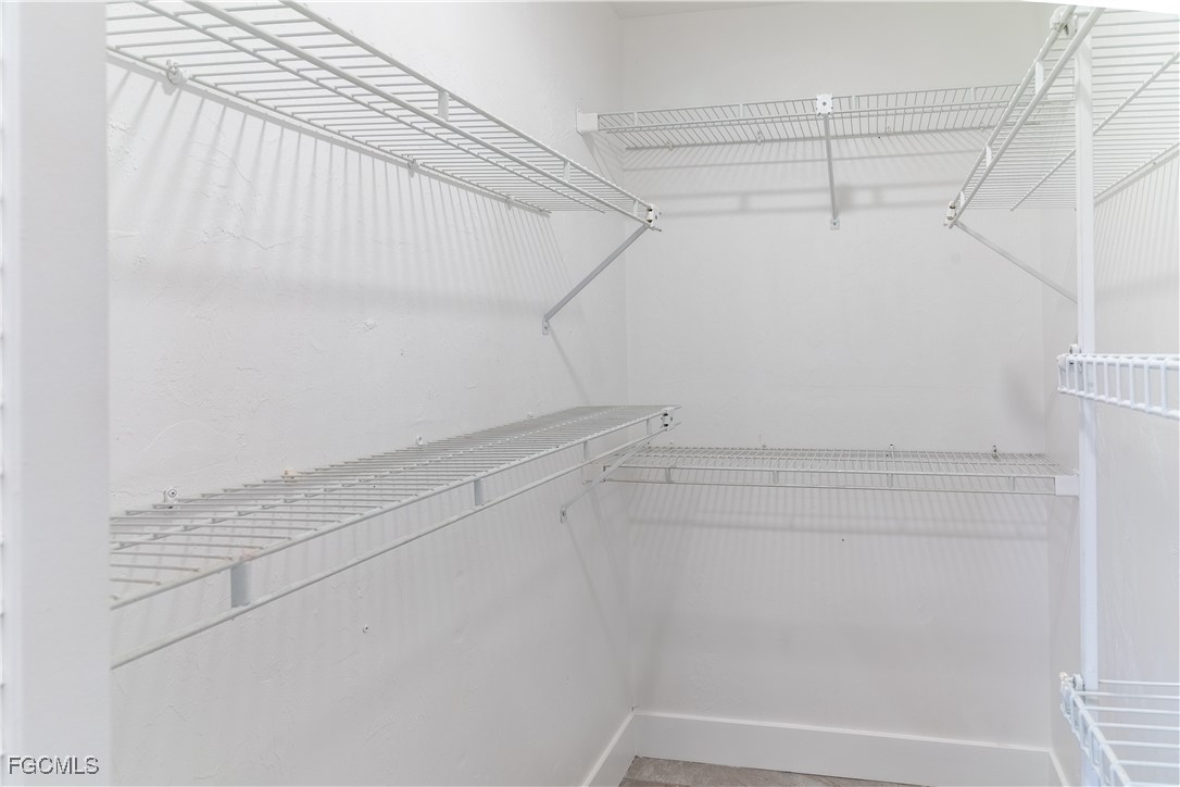 720 Chavers Street East Lehigh Acres, FL 33974 - Photo 21 of 35 a view of a room with racks on the wall