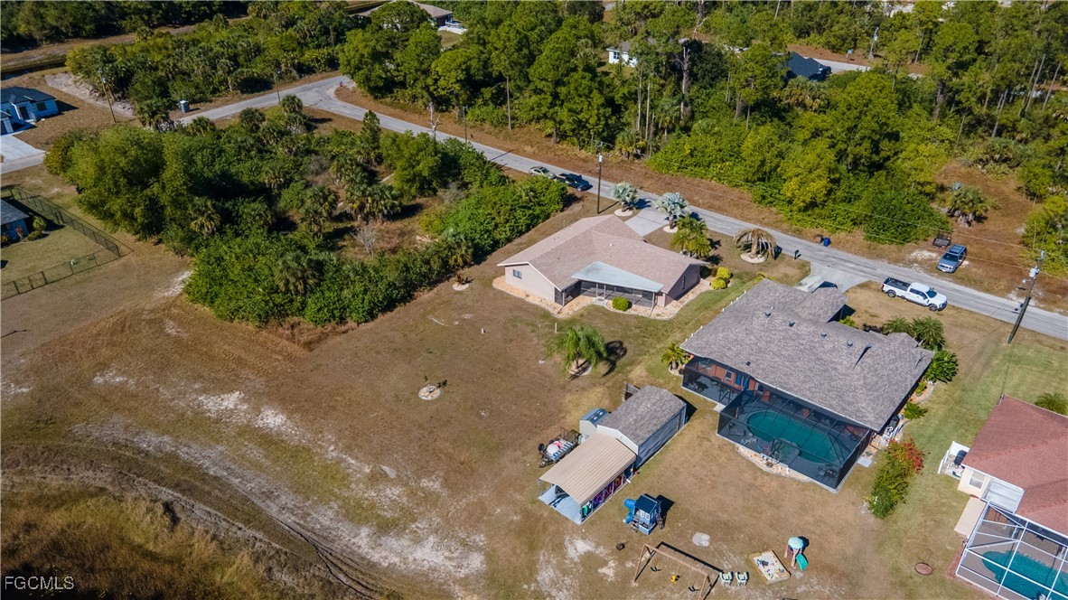 720 Chavers Street East Lehigh Acres, FL 33974 - Photo 29 of 35 an aerial view of a house with a yard