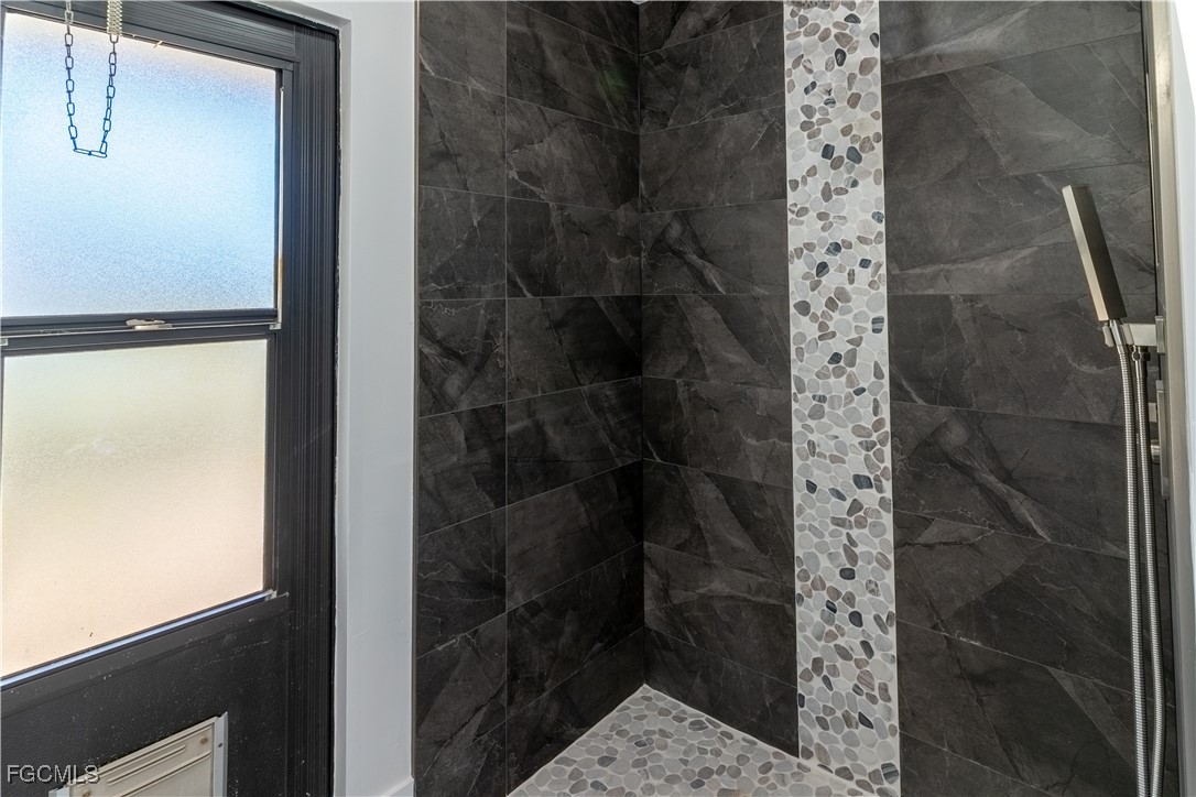 720 Chavers Street East Lehigh Acres, FL 33974 - Photo 10 of 35 a bathroom with a shower