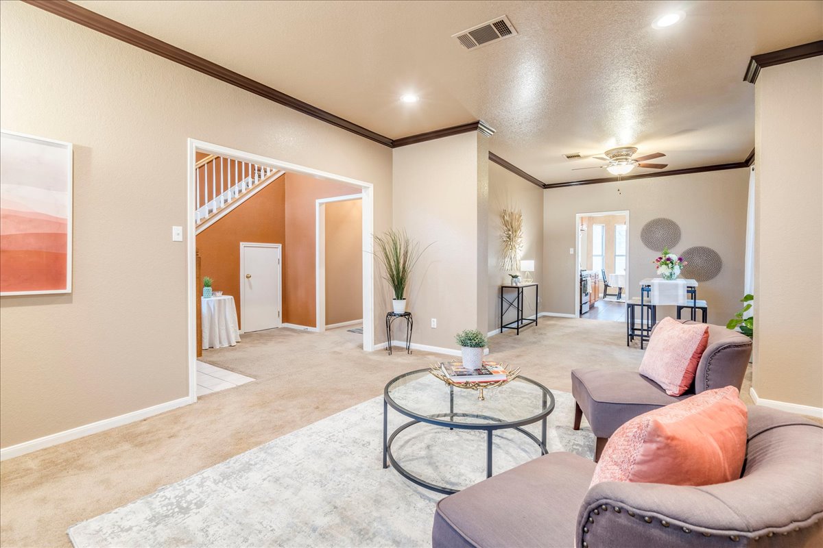 1706 Apache Trail Round Rock, TX 78665 - Photo 4 of 38 The Living Room/Dining Room are directly off of the entryway. This space is just waiting for a fun party or could be used as a Library, Music Room, an Office, etc. Check out the crown molding, double doorway, and size of these rooms!