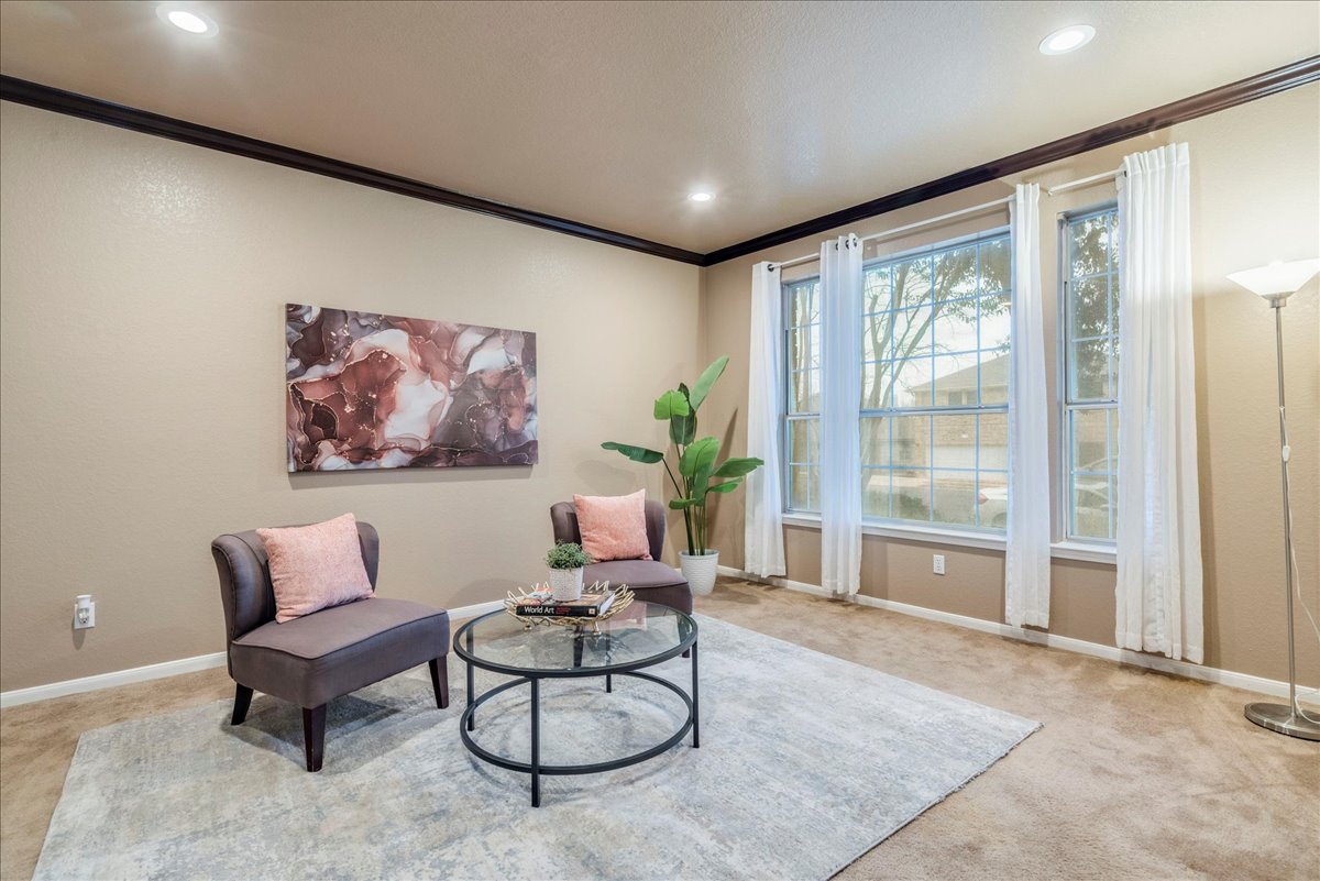 1706 Apache Trail Round Rock, TX 78665 - Photo 5 of 38 The Living Room has large windows looking out to the front of the house.