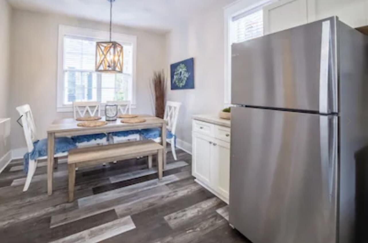 198 Somerset Bridge Road, Unit 141 Santa Rosa Beach, FL 32459 - Photo 11 of 31 a kitchen with stainless steel appliances a refrigerator a table and chairs