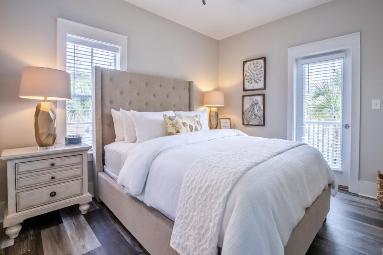 198 Somerset Bridge Road, Unit 141 Santa Rosa Beach, FL 32459 - Photo 16 of 31 a bedroom with a large bed and wooden floor