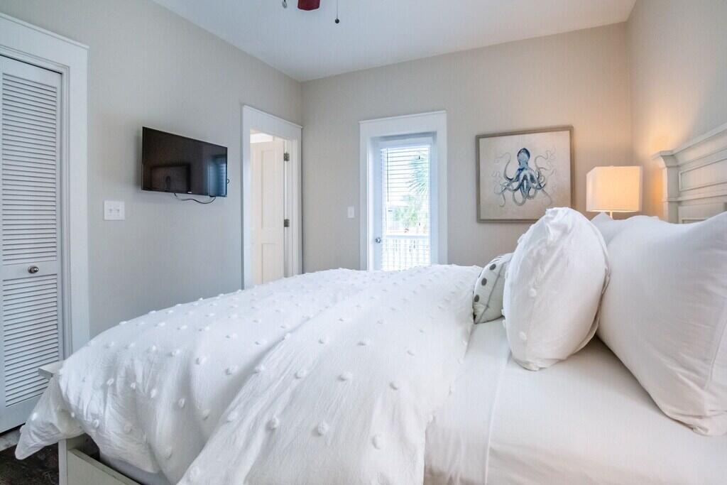 198 Somerset Bridge Road, Unit 141 Santa Rosa Beach, FL 32459 - Photo 21 of 31 a bedroom with a bed and a flat screen tv