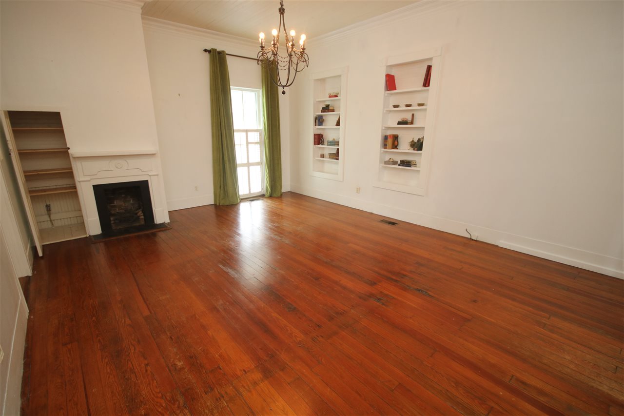 6810 Berryhill Road Milton, FL 32570 - Photo 11 of 50 fireplace & beautiful Heart Pine flooring.
