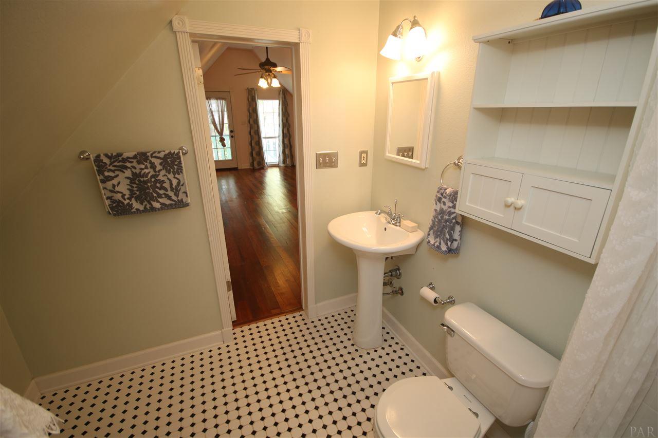 6810 Berryhill Road Milton, FL 32570 - Photo 49 of 50 flooring, pedestal sink & tub/shower.