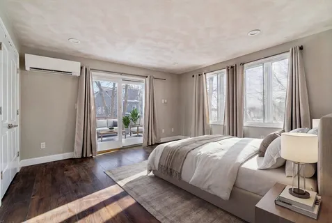 a bedroom with a bed and a large window