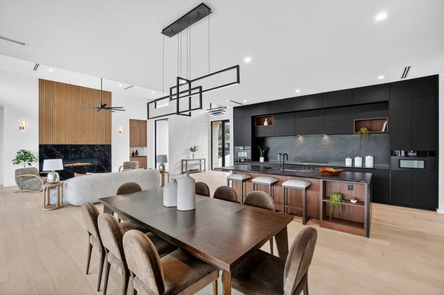 a bedroom with a bed a lamp and a large window