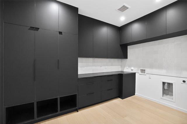 a bedroom with a bed and a dresser with mirror