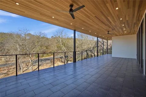 an empty room with windows and city view