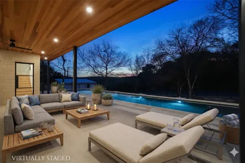 a view of swimming pool with outdoor seating