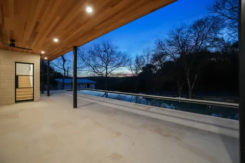 a balcony with tall trees