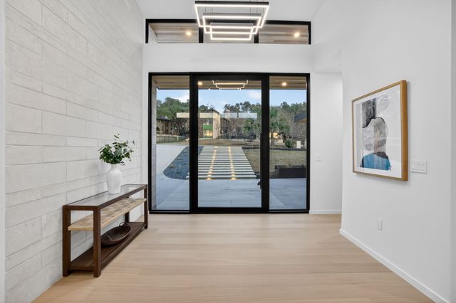 a view of a roof deck with couches and wooden floor