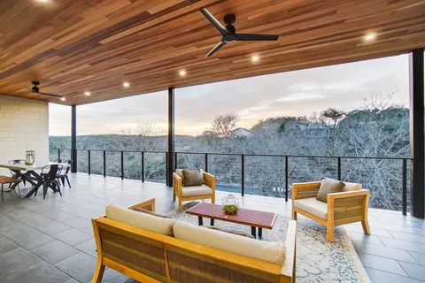 a view of a roof deck with couches and wooden floor