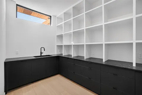 a kitchen with a refrigerator and a sink