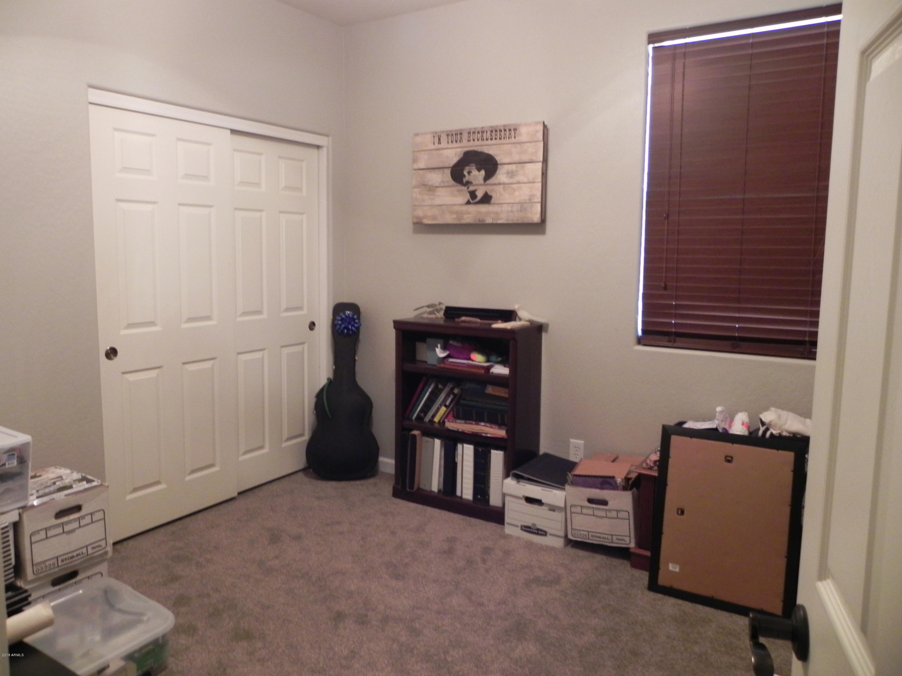 18005 West Hatcher Road Waddell, AZ 85355 - Photo 9 of 18 a view of a workspace with furniture and a window
