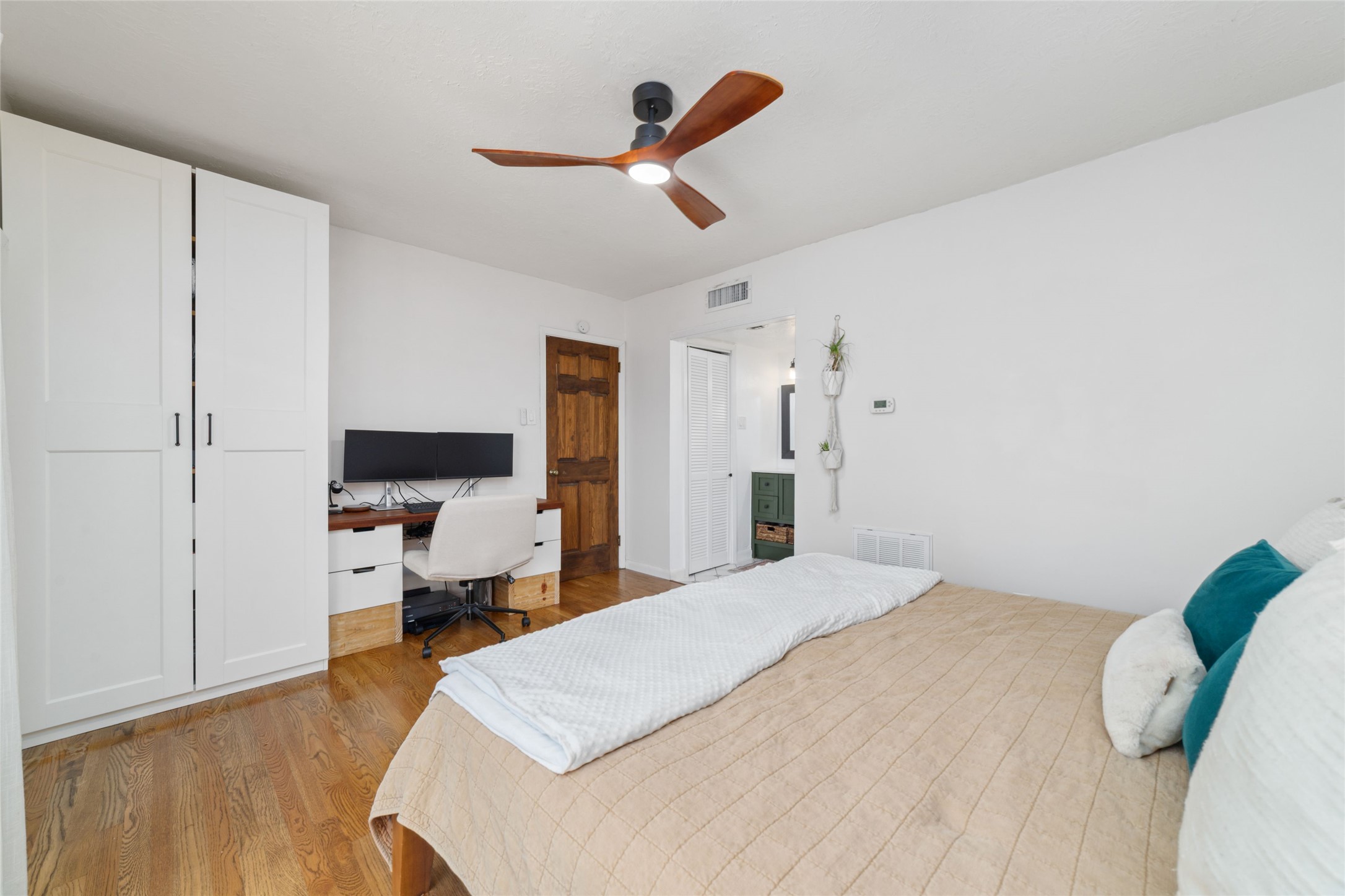 3400 Timmons Lane, Unit 68 Houston, TX 77027 - Photo 11 of 20 a bedroom with a bed and wooden floor