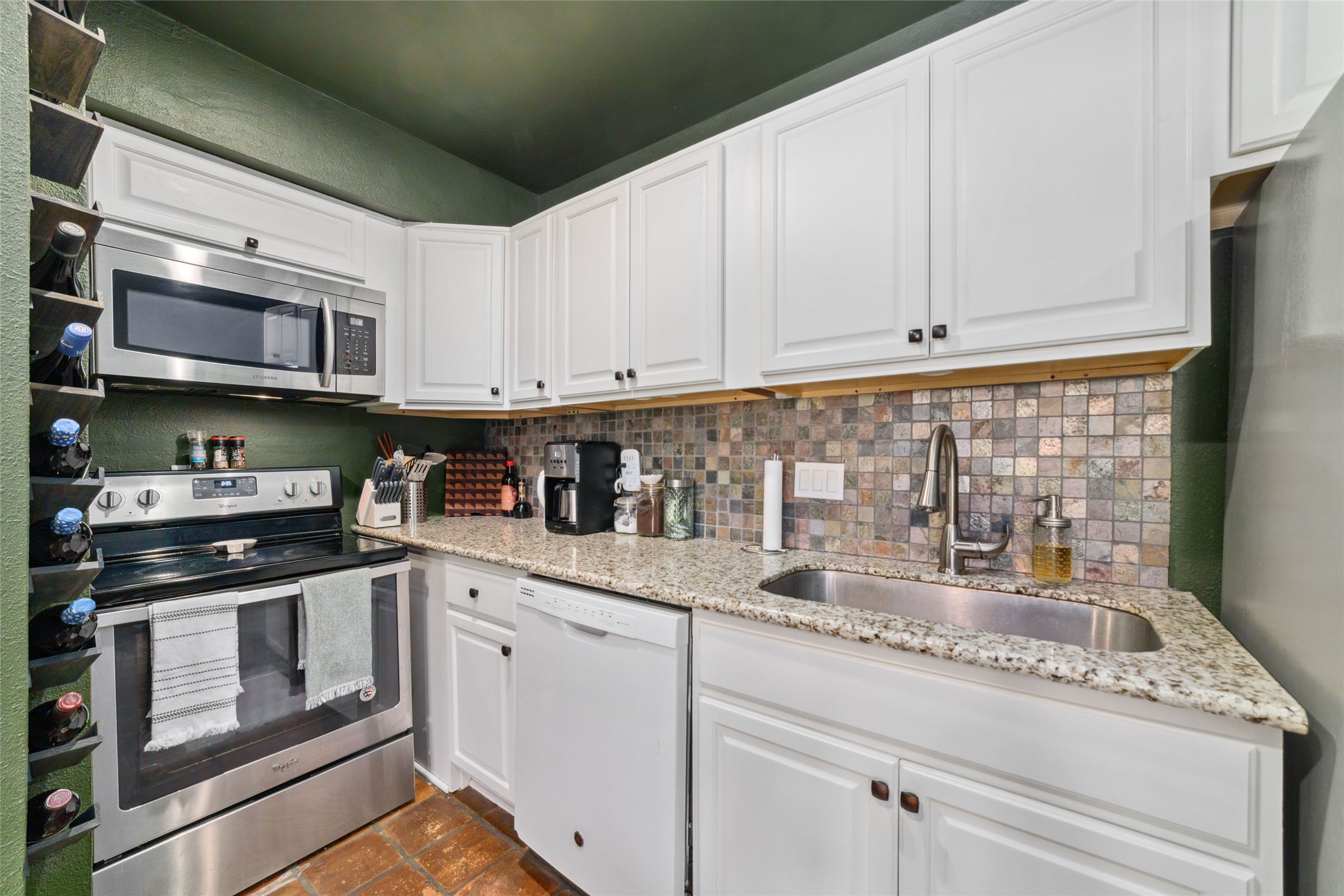 3400 Timmons Lane, Unit 68 Houston, TX 77027 - Photo 13 of 20 a kitchen with stainless steel appliances granite countertop a stove and cabinets