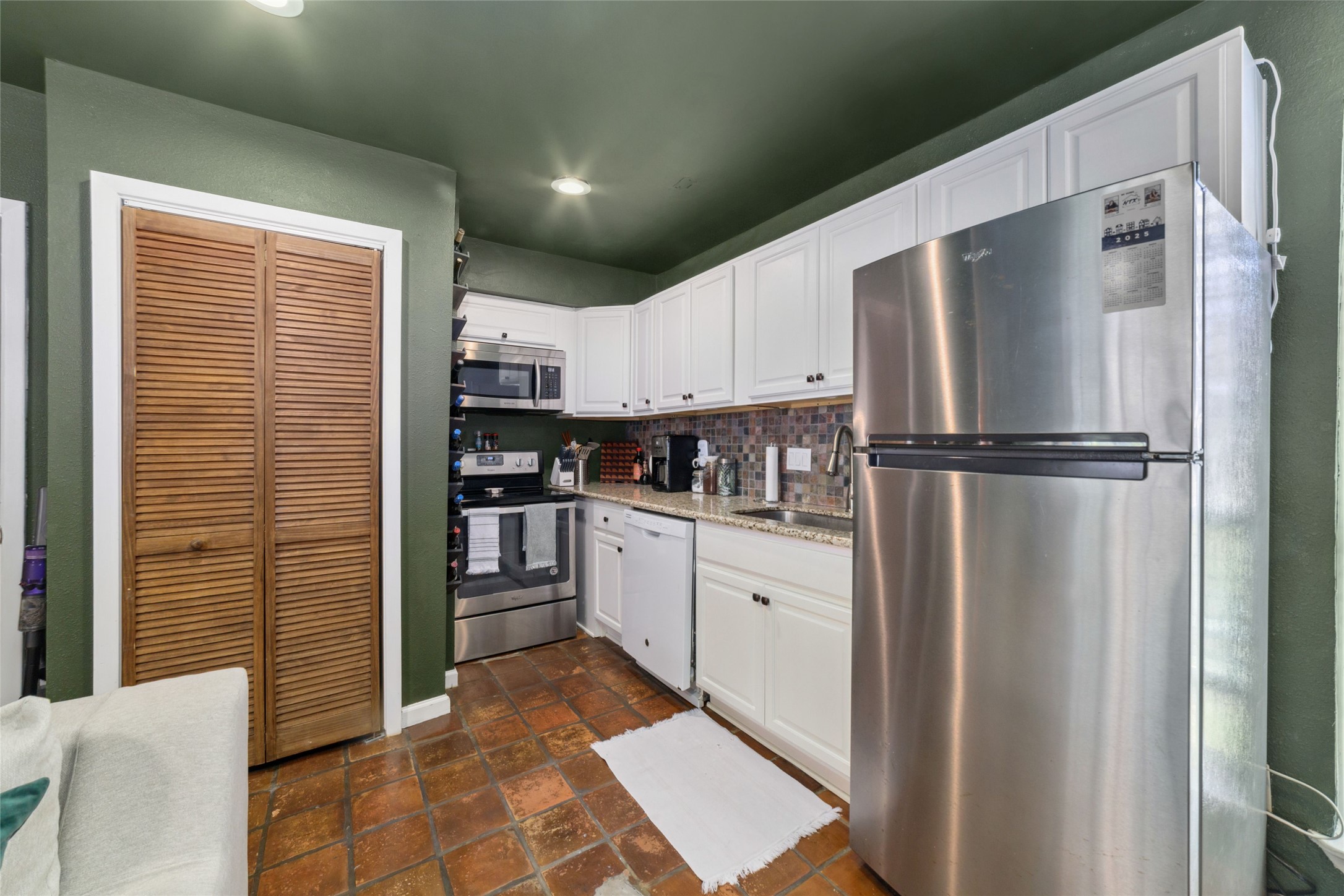 3400 Timmons Lane, Unit 68 Houston, TX 77027 - Photo 15 of 20 a kitchen with stainless steel appliances granite countertop a refrigerator and a stove top oven