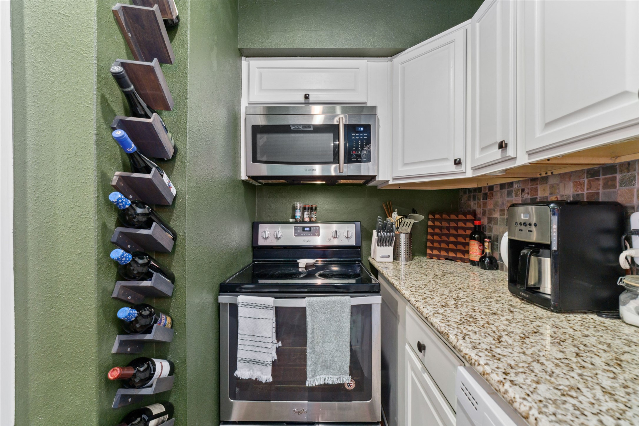 3400 Timmons Lane, Unit 68 Houston, TX 77027 - Photo 16 of 20 a kitchen with stainless steel appliances granite countertop a stove and cabinets