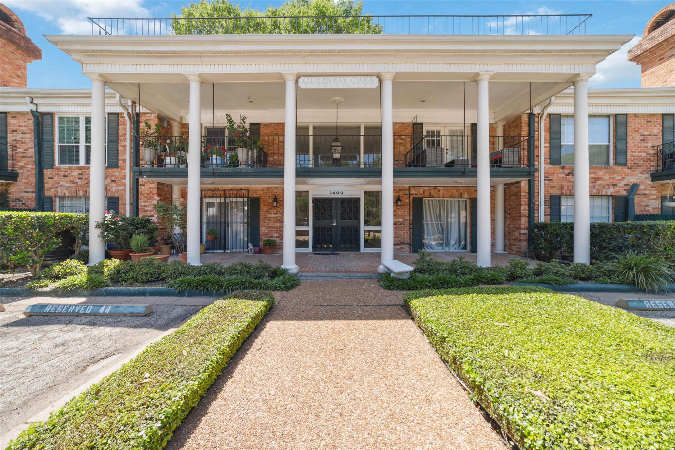 3400 Timmons Lane, Unit 68 Houston, TX 77027 - Photo 18 of 20 front view of a brick house with a yard